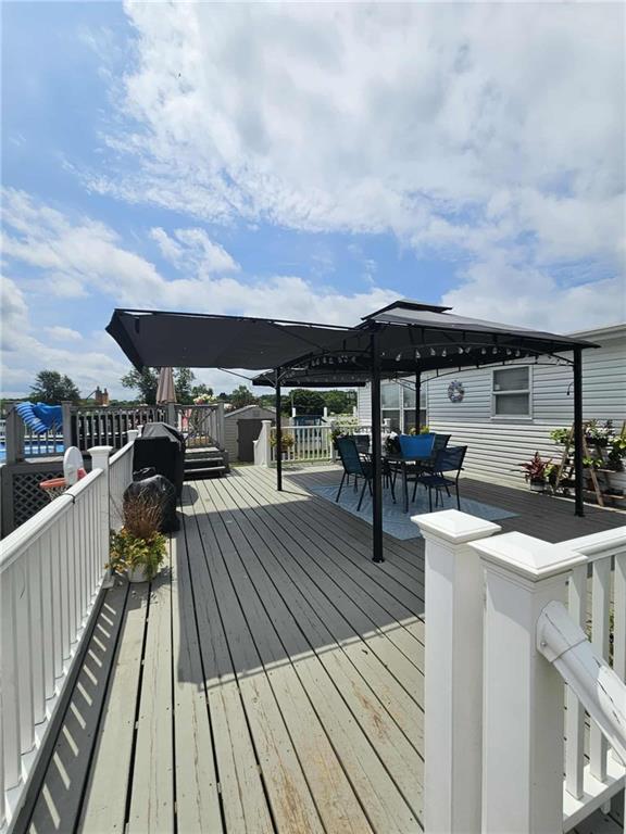 145 Boomerang Road Harrisville, PA 16038 - Photo 28 of 37 a view of a roof deck with table and chairs a stove with wooden floor