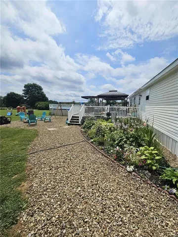 a view of a garden with lawn chairs