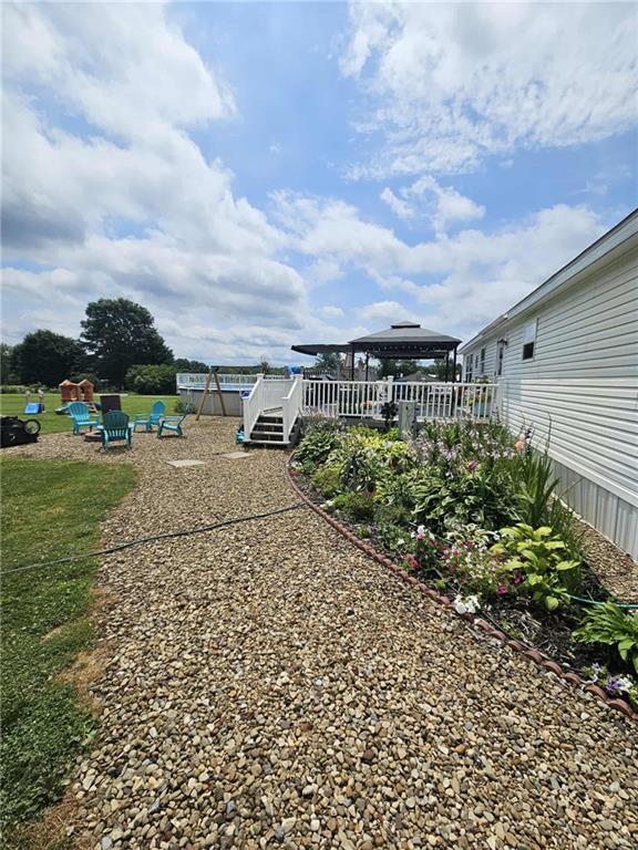 145 Boomerang Road Harrisville, PA 16038 - Photo 3 of 37 a view of a garden with lawn chairs