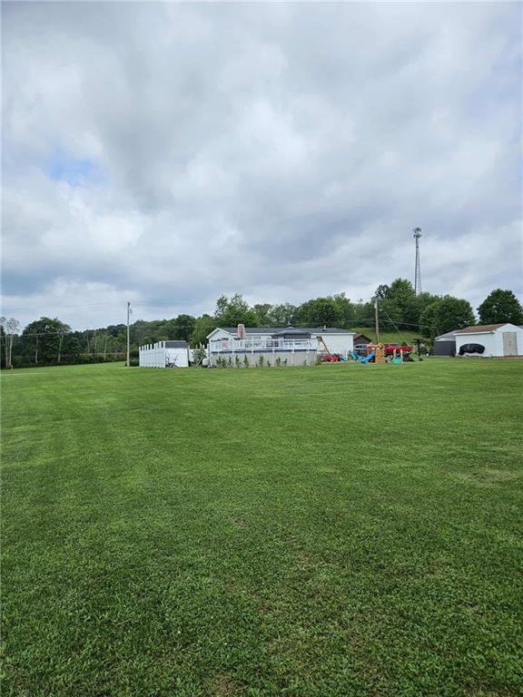 145 Boomerang Road Harrisville, PA 16038 - Photo 35 of 37 a view of a green field with house in the back