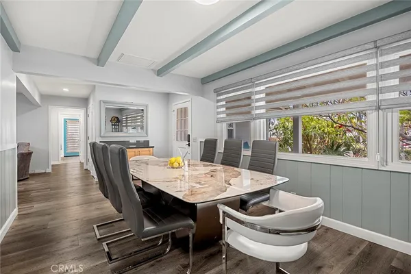 a kitchen with sink refrigerator dining table and chairs