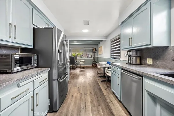 a en suite bathroom with a granite countertop sink and a large mirror