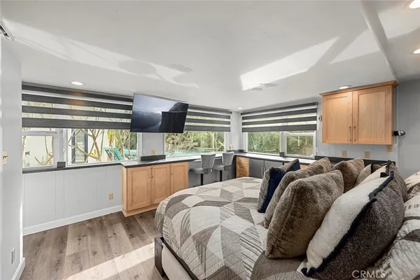 a bathroom with a granite countertop double vanity sink a mirror and a shower