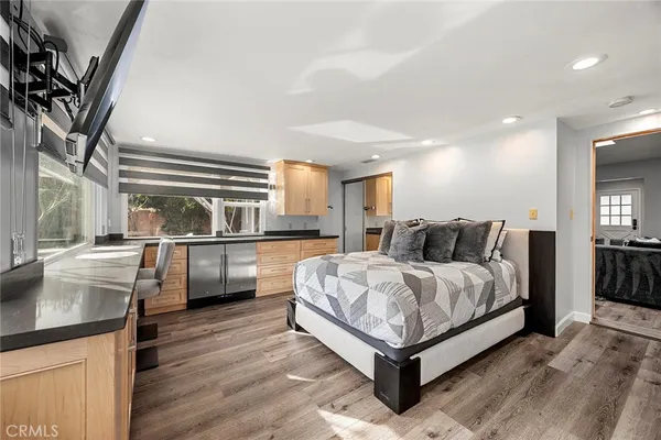 a view of walk in closet with wooden floor and fan