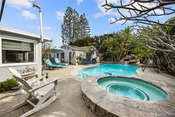 a front view of a house with swimming pool and porch