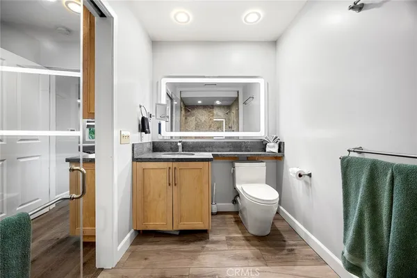 a bathroom with a sink a mirror and a shower