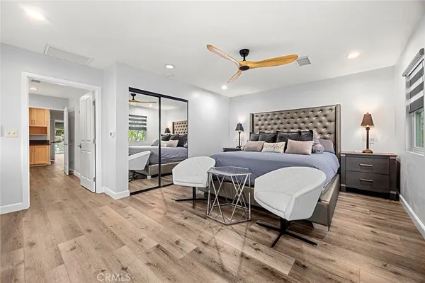 a bedroom with a bed and a table next to a window