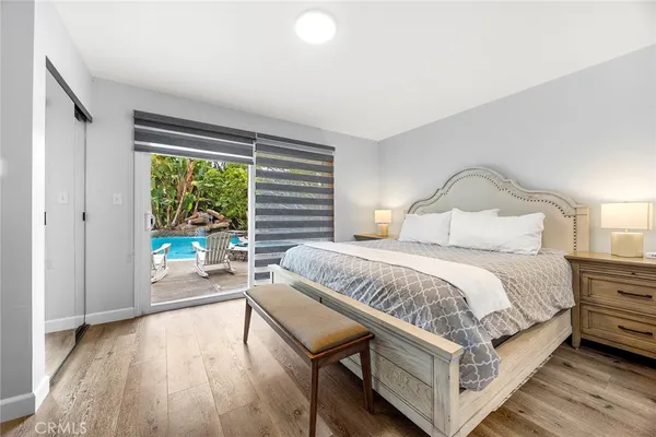 a view of a swimming pool with a yard and sitting area