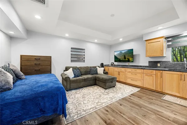 a bathroom with a granite countertop sink a toilet a shower and a mirror