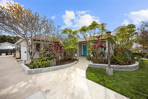 a view of a white house with a yard