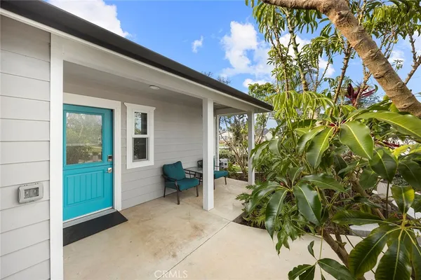 a view of a patio with table and chairs and potted plants