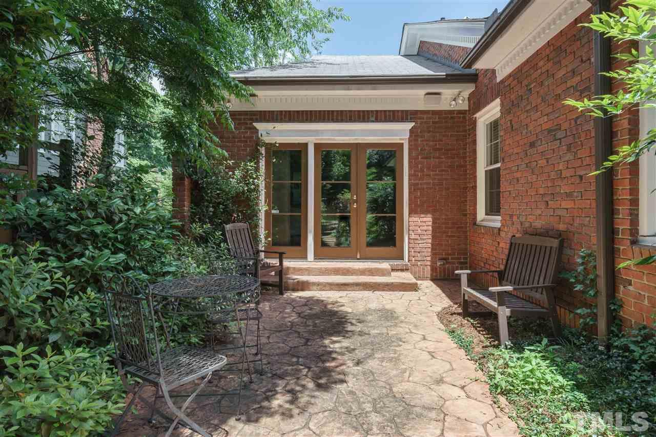 2237 The Circle Raleigh, NC 27608 - Photo 12 of 22 a front view of a house with outdoor seating and plants