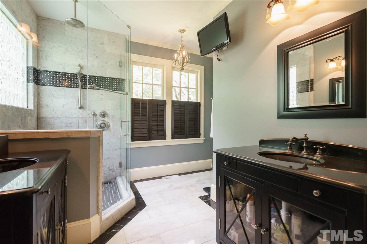 2237 The Circle Raleigh, NC 27608 - Photo 13 of 22 a bathroom with a sink a vanity and a mirror