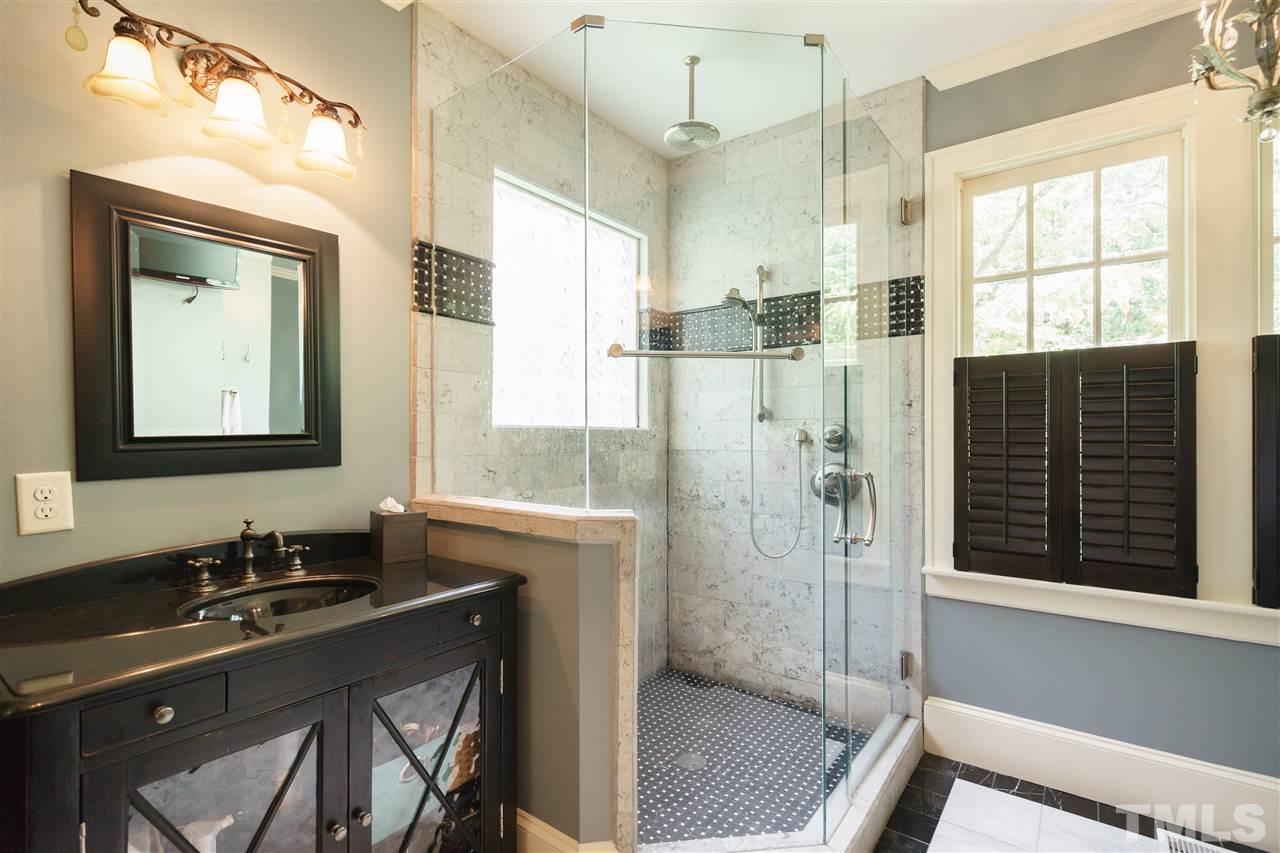 2237 The Circle Raleigh, NC 27608 - Photo 14 of 22 a bathroom with a granite countertop sink a mirror and shower