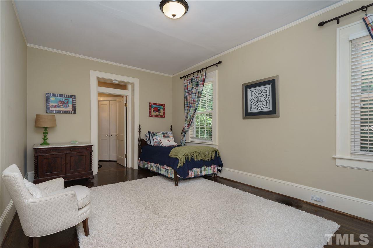 2237 The Circle Raleigh, NC 27608 - Photo 15 of 22 a bedroom with a bed and wooden floor