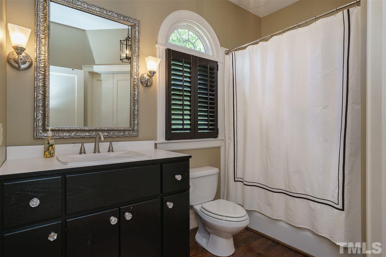 2237 The Circle Raleigh, NC 27608 - Photo 16 of 22 a bathroom with a toilet a sink and mirror