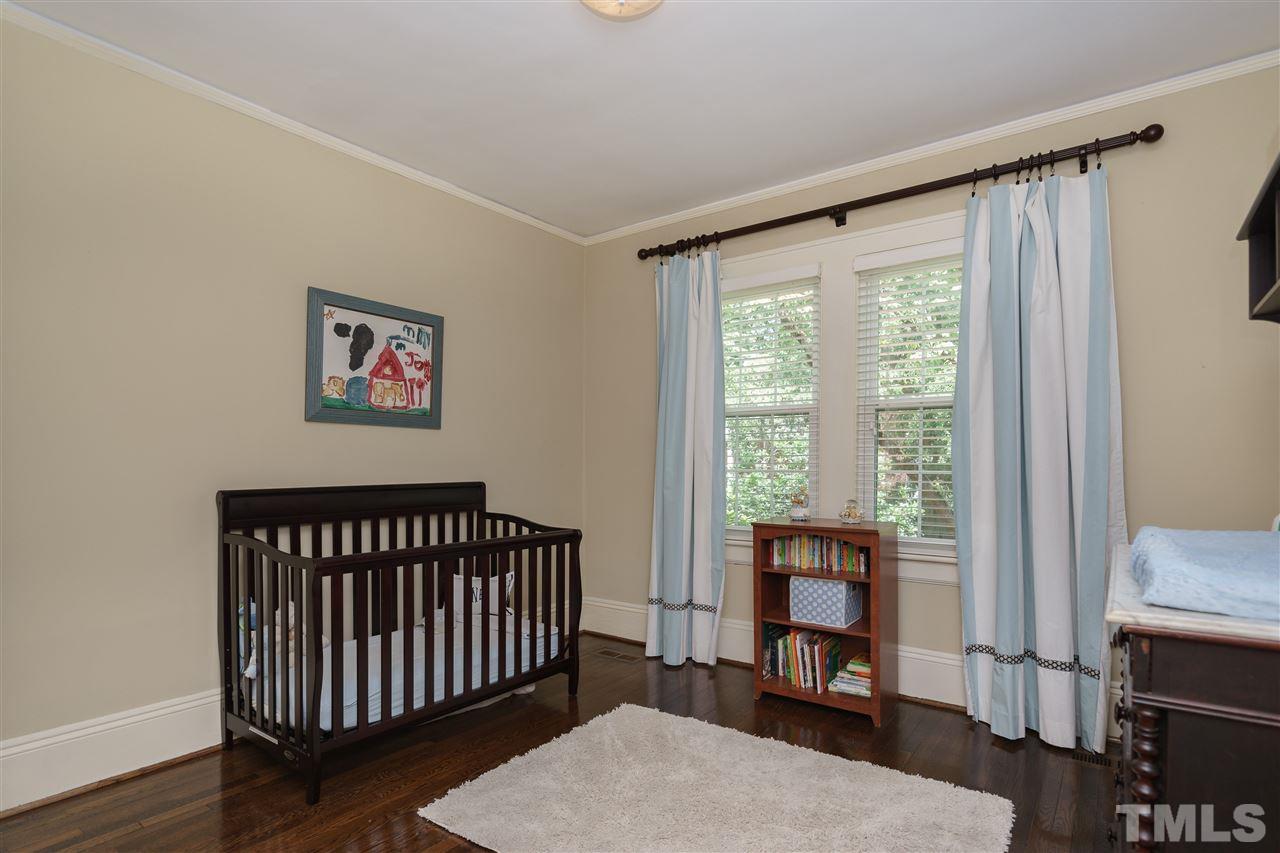 2237 The Circle Raleigh, NC 27608 - Photo 17 of 22 a view of a bedroom with furniture and a window