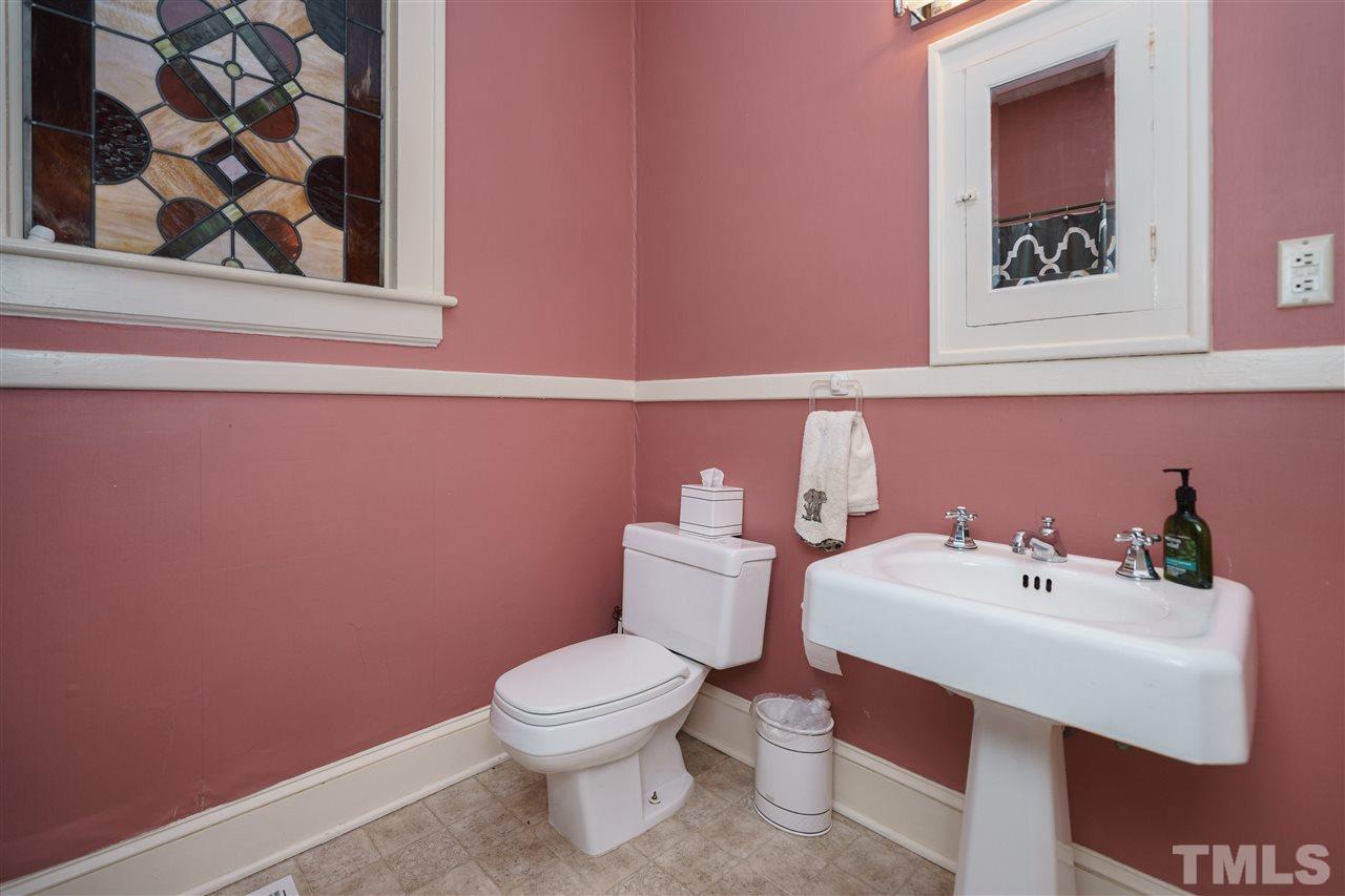 2237 The Circle Raleigh, NC 27608 - Photo 18 of 22 a bathroom with a toilet sink and mirror