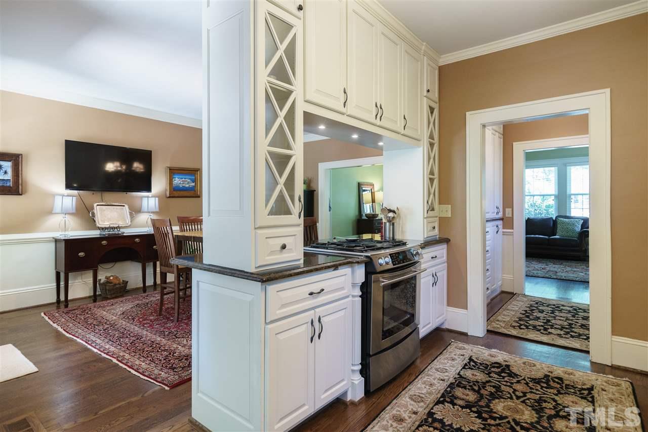 2237 The Circle Raleigh, NC 27608 - Photo 6 of 22 a kitchen with stainless steel appliances granite countertop a stove and cabinets