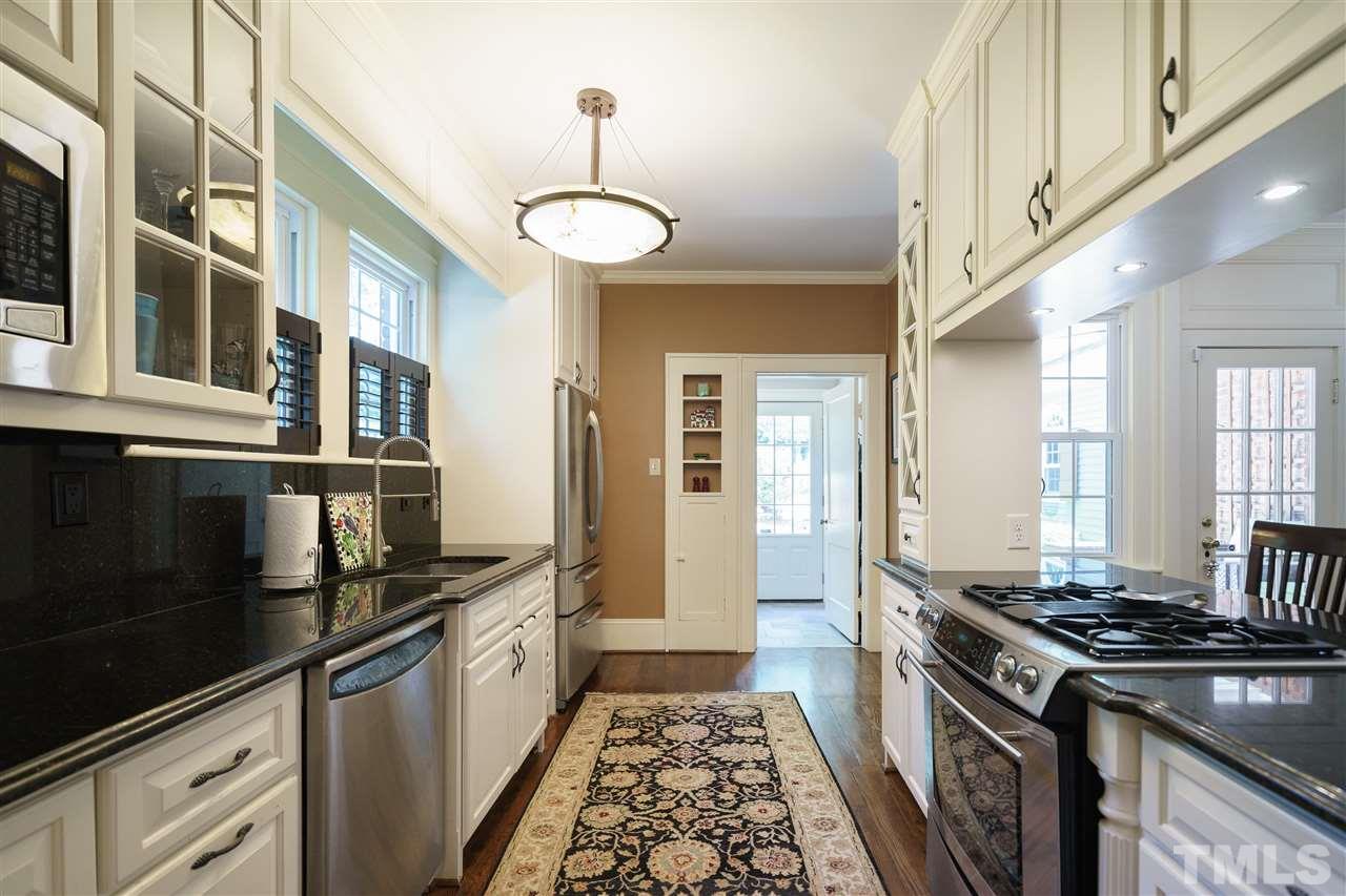 2237 The Circle Raleigh, NC 27608 - Photo 7 of 22 a kitchen with stainless steel appliances granite countertop a stove and a sink