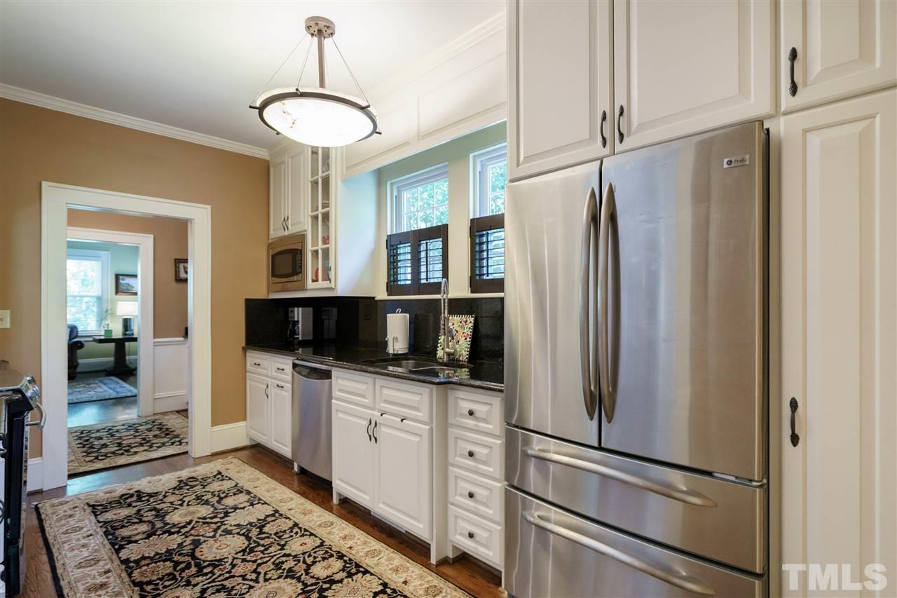 2237 The Circle Raleigh, NC 27608 - Photo 8 of 22 a kitchen with stainless steel appliances granite countertop a refrigerator and a sink