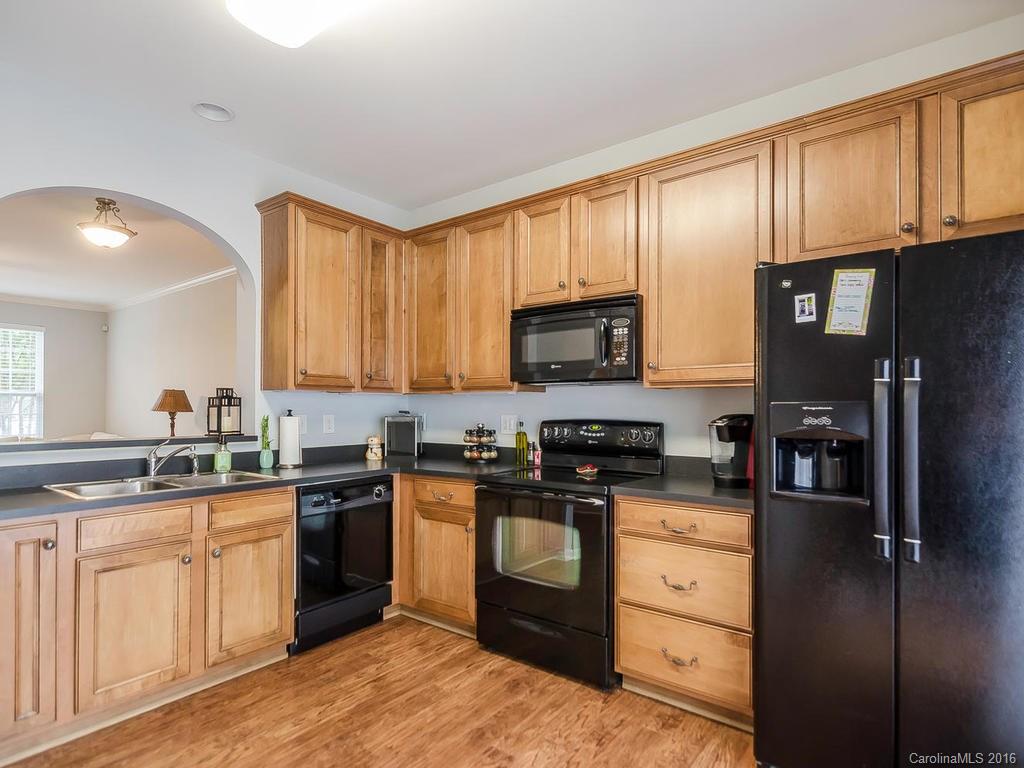 108 Chimney Rock Lane, Unit 16 Fort Mill, SC 29708 - Photo 9 of 21 a kitchen with stainless steel appliances granite countertop a stove a sink dishwasher a refrigerator and cabinets with wooden floor