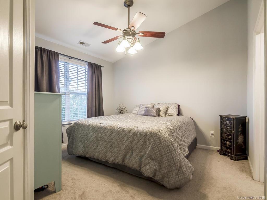 108 Chimney Rock Lane, Unit 16 Fort Mill, SC 29708 - Photo 10 of 21 a bedroom with a bed and a chandelier