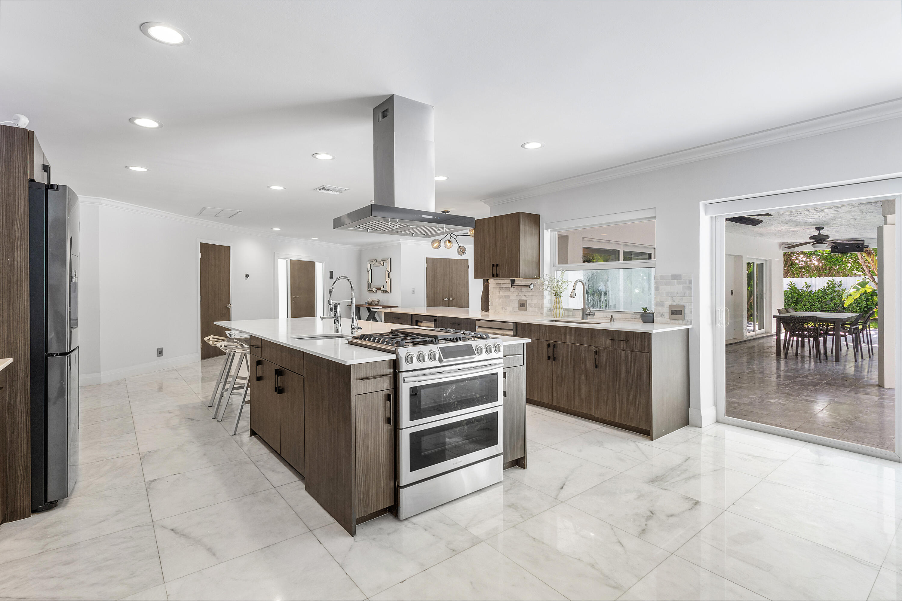 960 Southwest 18th Street Boca Raton, FL 33486 - Photo 11 of 40 a kitchen with stainless steel appliances granite countertop a stove and a refrigerator