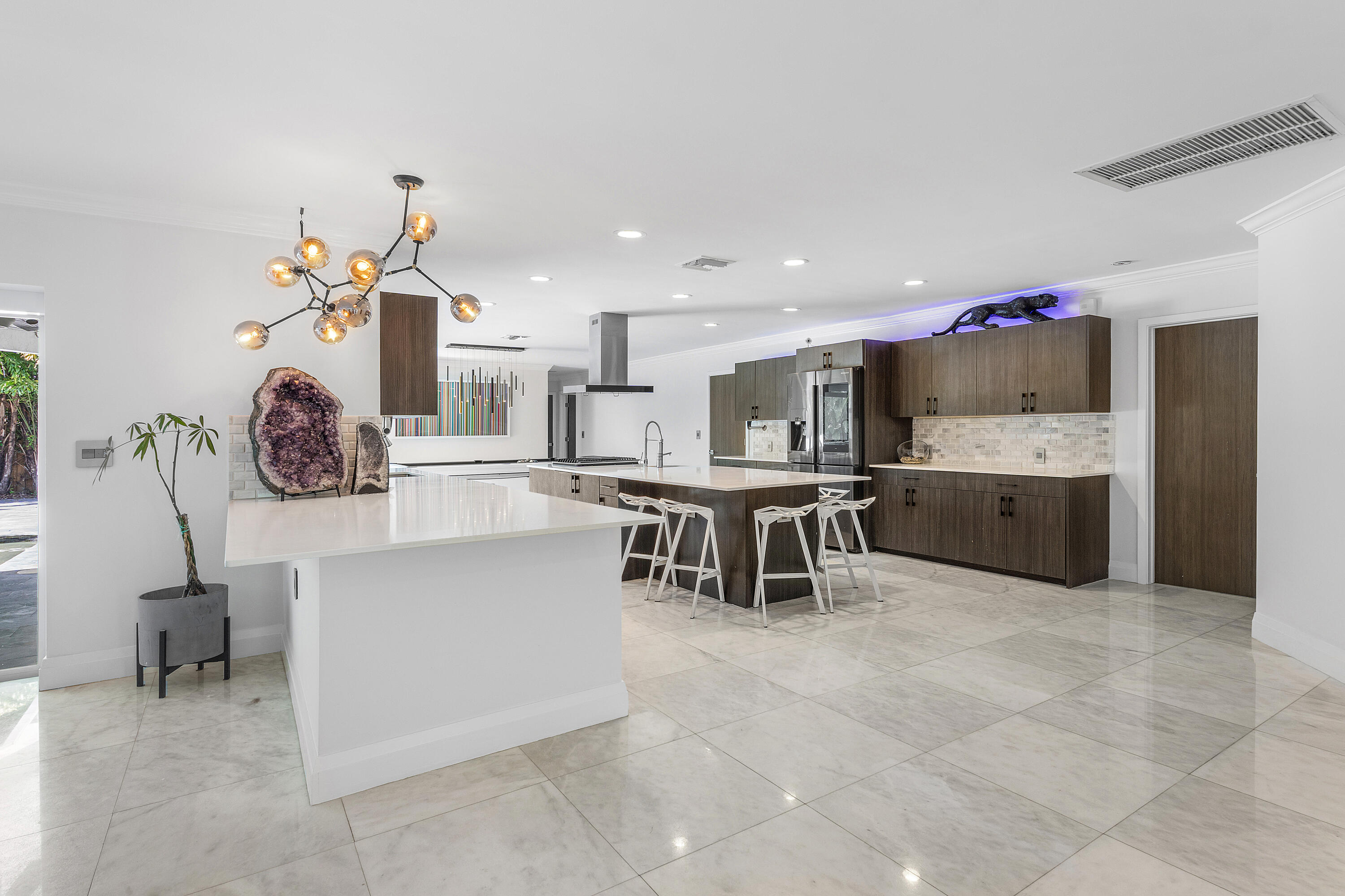 960 Southwest 18th Street Boca Raton, FL 33486 - Photo 13 of 40 a large white kitchen with a table and chairs