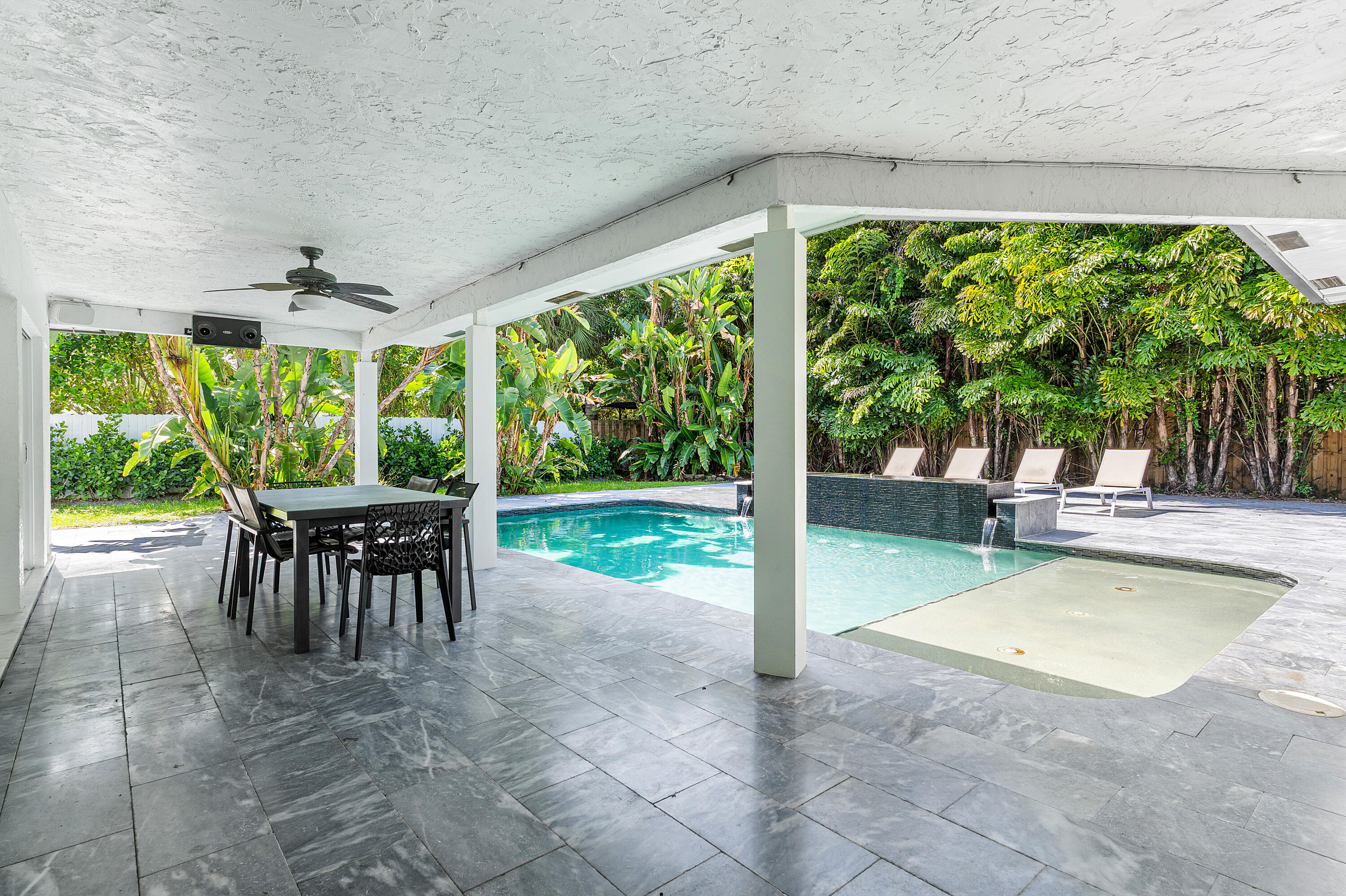 960 Southwest 18th Street Boca Raton, FL 33486 - Photo 23 of 40 a view of a patio with a table chairs and a backyard