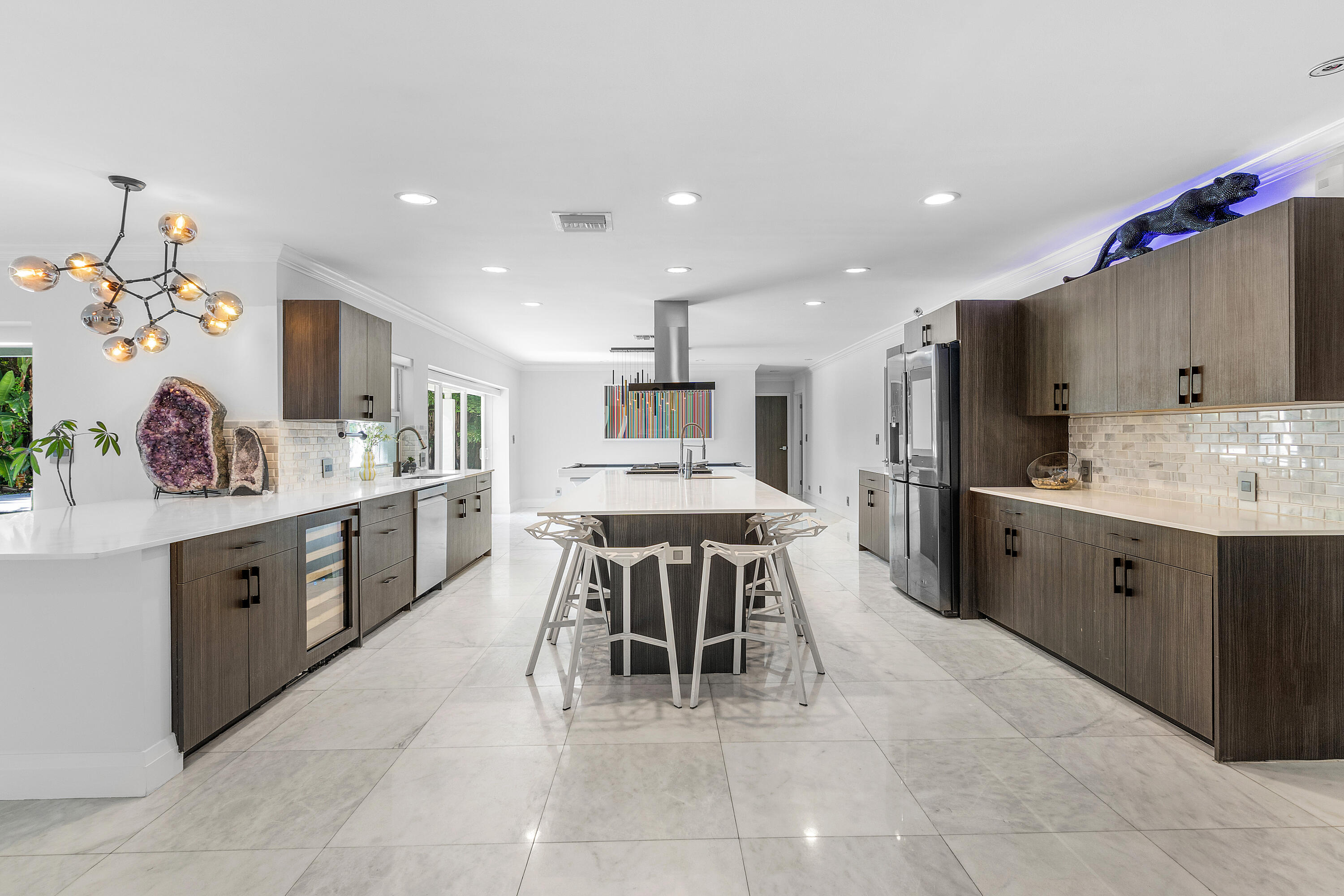 960 Southwest 18th Street Boca Raton, FL 33486 - Photo 9 of 40 a kitchen with stainless steel appliances kitchen island granite countertop a sink and cabinets
