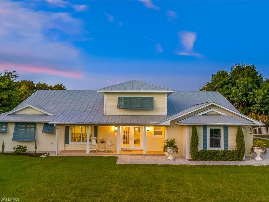 624 Ridge Drive Naples, FL 34108 - Photo 11 of 50 a front view of a house with a yard