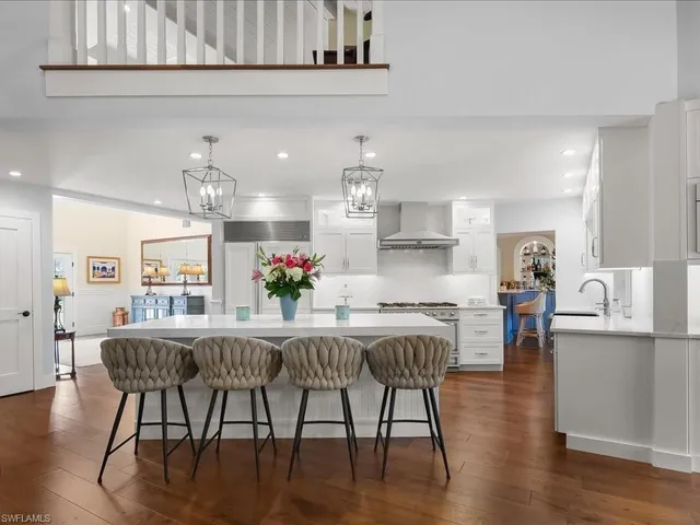 a kitchen with stainless steel appliances a sink stove and cabinets