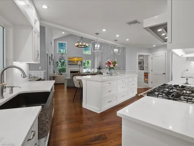 a kitchen with counter top space sink and center island