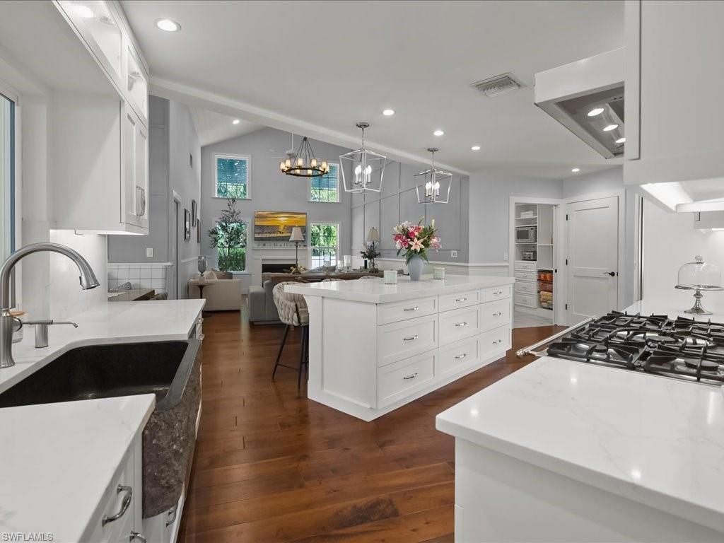 624 Ridge Drive Naples, FL 34108 - Photo 17 of 50 a kitchen with stainless steel appliances a sink stove and cabinets