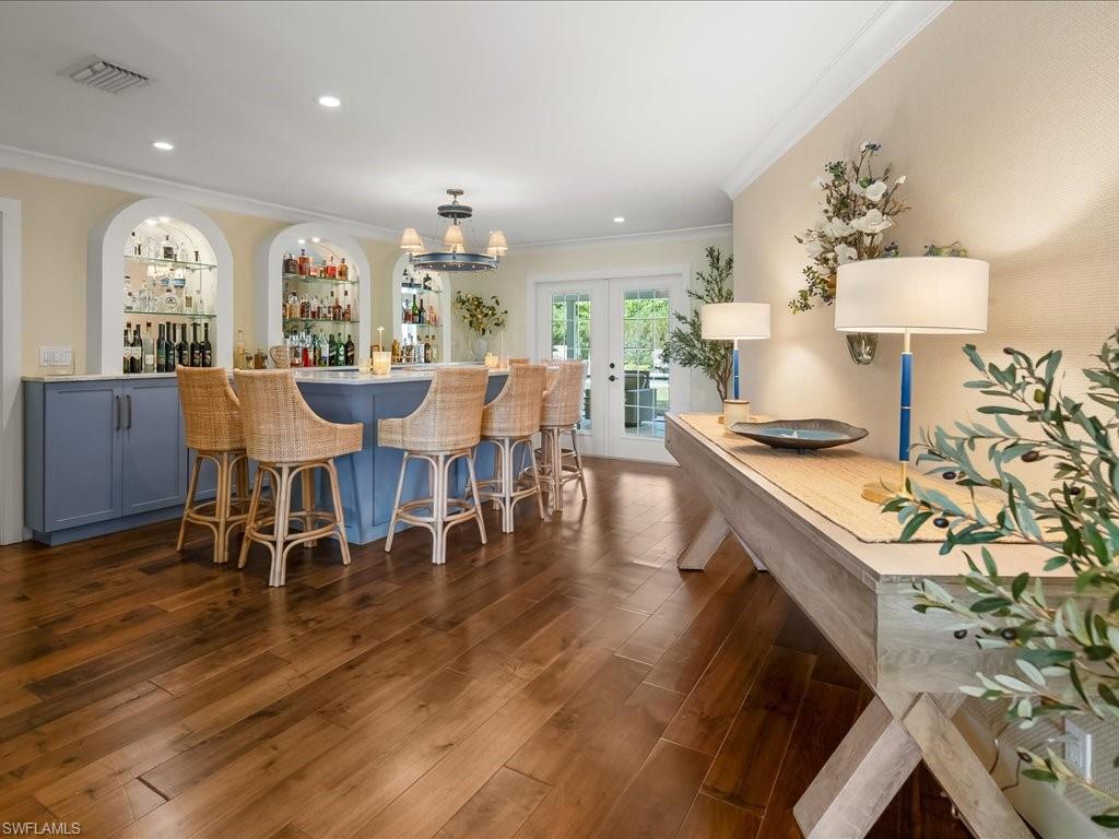 624 Ridge Drive Naples, FL 34108 - Photo 19 of 50 a view of a dining room with furniture and wooden floor