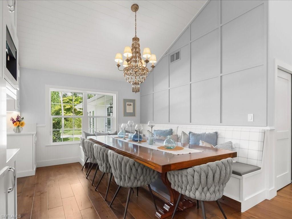 624 Ridge Drive Naples, FL 34108 - Photo 22 of 50 a dining room with furniture a rug a potted plant and a chandelier