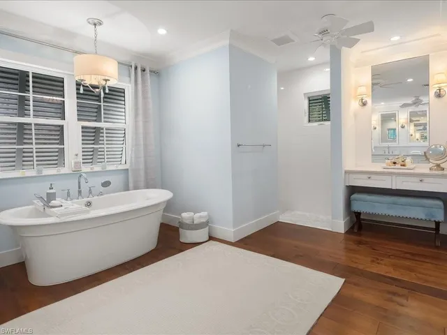 a spacious bathroom with a granite countertop sink and a mirror