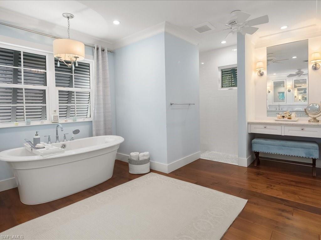 624 Ridge Drive Naples, FL 34108 - Photo 25 of 50 a spacious bathroom with double vanity and a bathtub