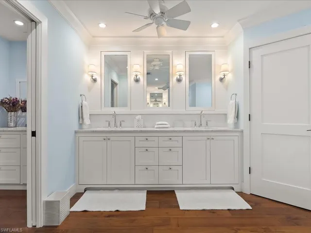 a en suite bathroom with a granite countertop sink and a mirror