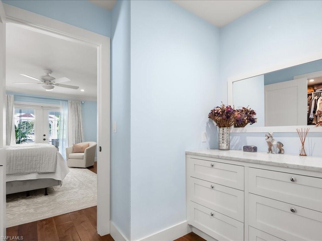 624 Ridge Drive Naples, FL 34108 - Photo 27 of 50 a en suite bathroom with a granite countertop sink and a mirror