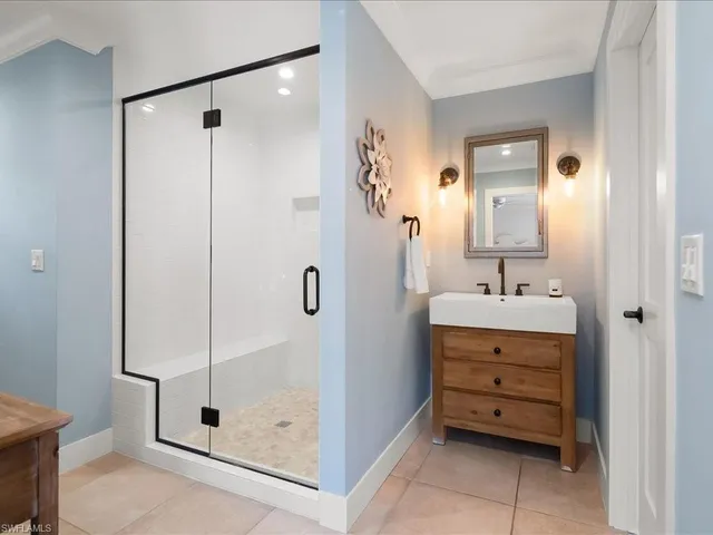 a bedroom with a bed lamp and a large window