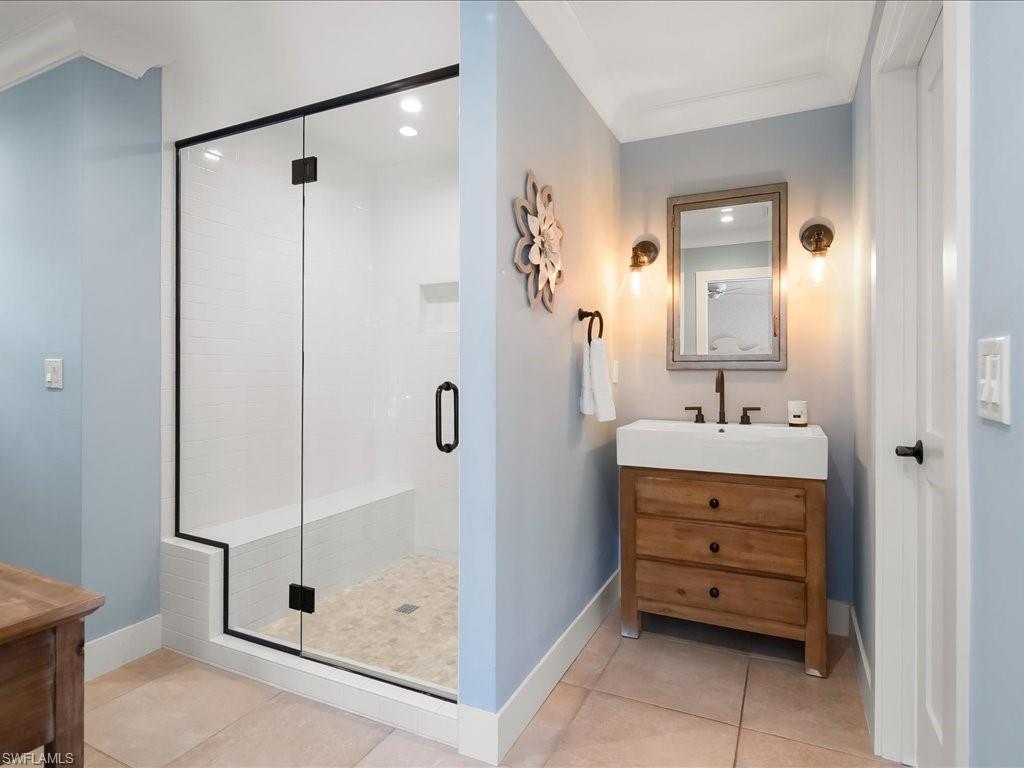 624 Ridge Drive Naples, FL 34108 - Photo 31 of 50 a bathroom with a sink a shower and mirror