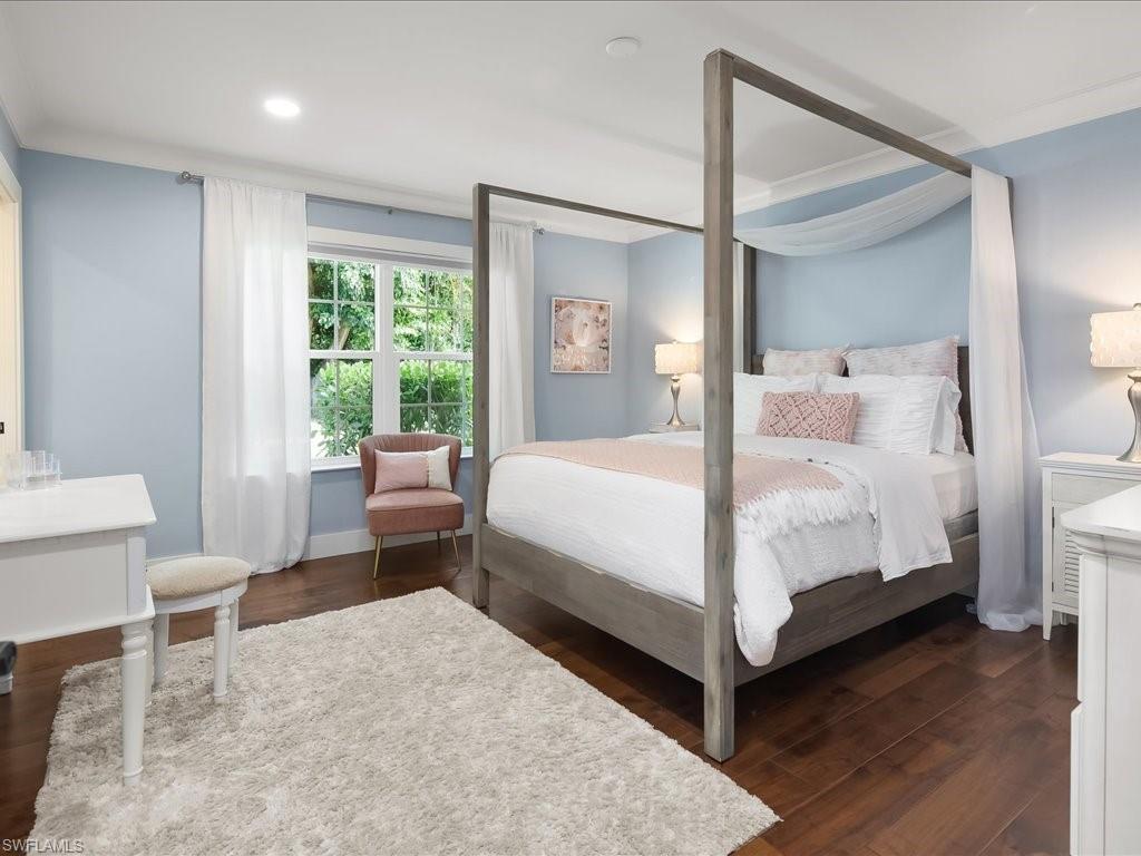 624 Ridge Drive Naples, FL 34108 - Photo 32 of 50 a bedroom with a bed lamp and a large window