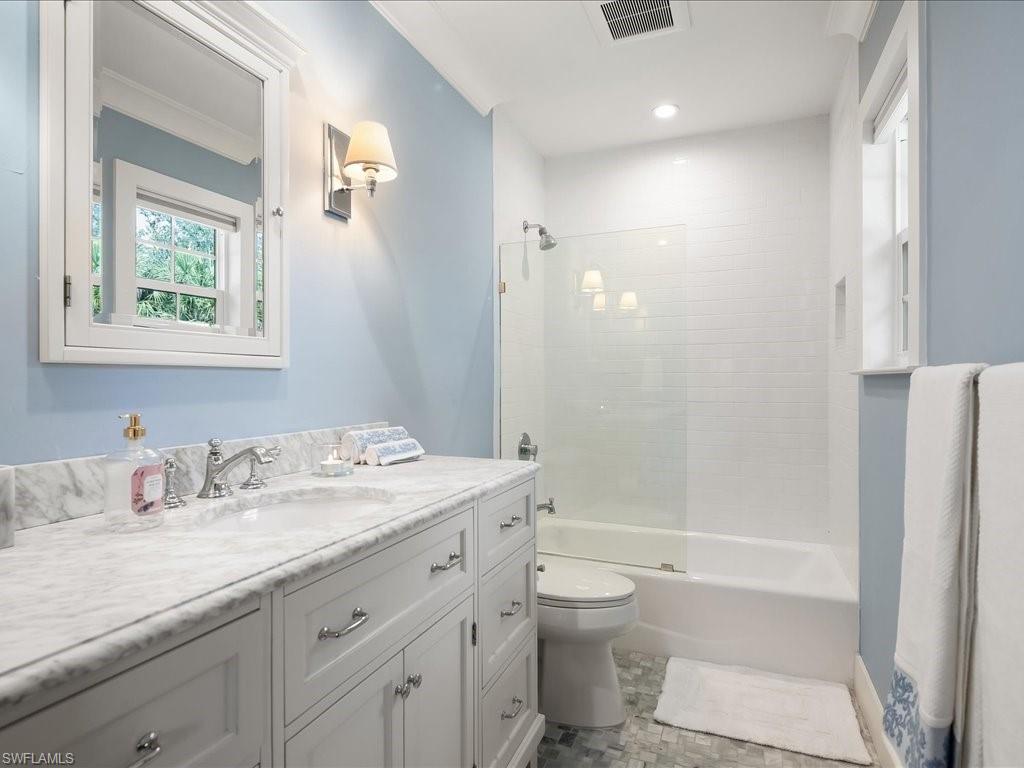 624 Ridge Drive Naples, FL 34108 - Photo 33 of 50 a bathroom with a granite countertop sink toilet and shower