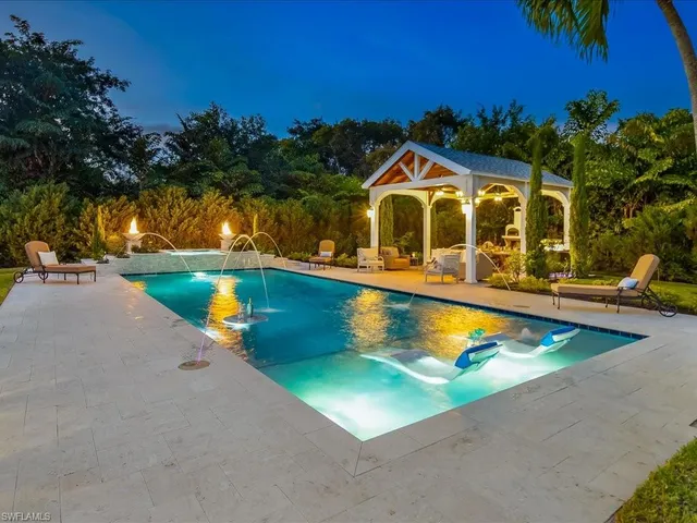 swimming pool view with a garden space
