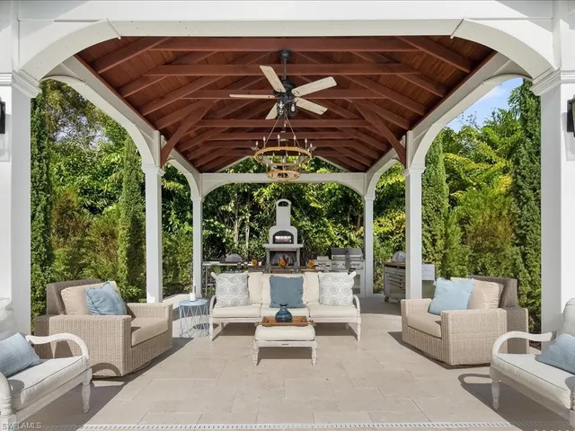 a view of an outside dining space with a table and chairs