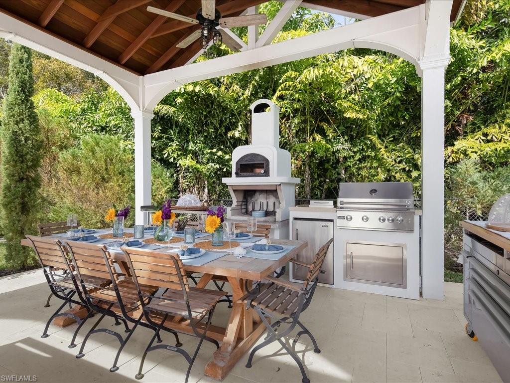 624 Ridge Drive Naples, FL 34108 - Photo 46 of 50 a view of an outside dining space with a table and chairs