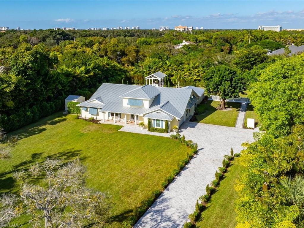 624 Ridge Drive Naples, FL 34108 - Photo 47 of 50 a view of a house with a yard