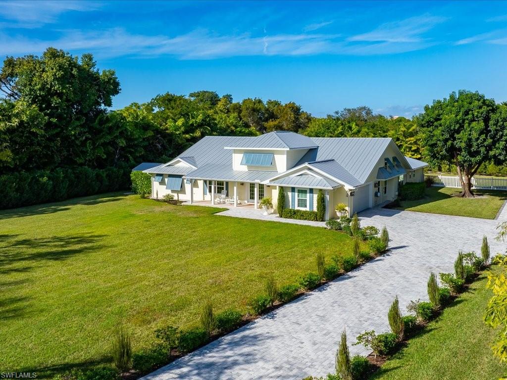 624 Ridge Drive Naples, FL 34108 - Photo 48 of 50 a aerial view of a house with a big yard